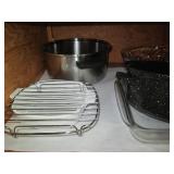 Cupboard of baking pans and kitchen...