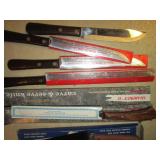 Wood box filled with new knives and...