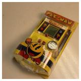 Handheld PAC MAN video game in original packaging
