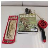 4 pc FISHING LOT ** BOOK ** JERK BAIT ** REEL AND ANOTHER BOOK