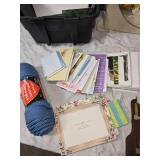 Craft Supplies with Yarn, Patterns, and Cross-Stitch Pillow