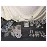 Elegant Crystal Glassware including Wine and Champagne Glasses, Decanter, and Ice Bucket