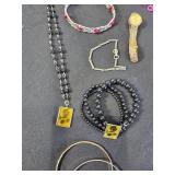 Assorted Jewelry with Necklaces, Bracelets, and Tokens