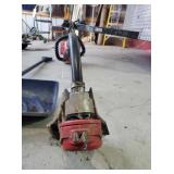 Troy Built gas weed whip and a shovel