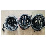 Three Bicycle Helmets in Various Sizes
