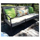 Outdoor Sofa with Tan Cushions and Decorative Pillows