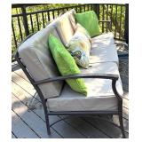 Outdoor Sofa with Tan Cushions and Decorative Pillows