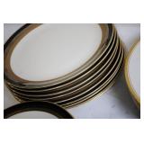 Set of Elegant Porcelain Dinnerware with Gold Trim and Decorative Plate