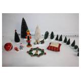 Collection of Holiday Decorations Including Nutcracker, Trees, and Ornaments
