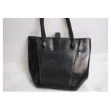 Black Leather Handbag with Intricate Silver Accent & Vintage Wooden Cabinet