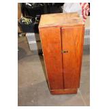 Black Leather Handbag with Intricate Silver Accent & Vintage Wooden Cabinet