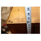 Black Leather Handbag with Intricate Silver Accent & Vintage Wooden Cabinet