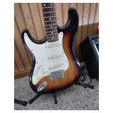 Vintage Johnson by AXL electric guitar with Peavey Rage 108 Amplifier and guitar stand.