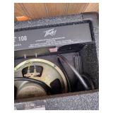 Vintage Johnson by AXL electric guitar with Peavey Rage 108 Amplifier and guitar stand.