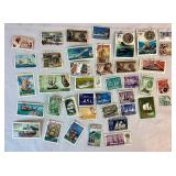 Collection of Themed International Stamps of Space, Airplanes, Flowers, Auto, Ships, Trains, Sports, Art and Costumes