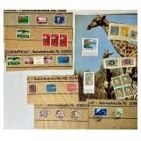 Bundle of Global Postage Stamps and 1982 USPS Stamp Album