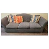 Used Sofa with Striped Throw Pillows