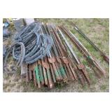 Collection of Electric Fence Supplies Including Wire, Insulators, and Energizer