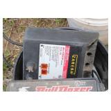 Collection of Electric Fence Supplies Including Wire, Insulators, and Energizer