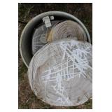 Collection of Electric Fence Supplies Including Wire, Insulators, and Energizer