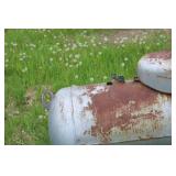 Collection of Steel Beams, Metal Scraps, and a Large Propane Tank