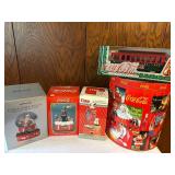Collection of Coca-Cola Memorabilia: Tins, Snow Globes, and Die-Cast Models