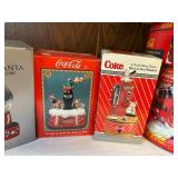 Collection of Coca-Cola Memorabilia: Tins, Snow Globes, and Die-Cast Models
