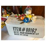 Collection of Christmas Decorations Including Santa Figurines and M&M Ornaments
