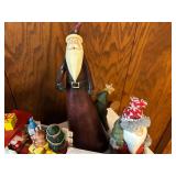 Collection of Christmas Decorations Including Santa Figurines and M&M Ornaments