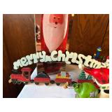 Collection of Christmas Decorations Including Santa Figurines and M&M Ornaments