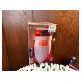 Collection of Christmas Decorations Including Santa Figurines and M&M Ornaments