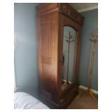 Antique Wooden Armoire with Intricate Carvings and Mirror