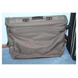 American Tourister Brown Garment Bag and Leisure International Black Upright Suitcase
