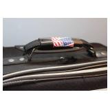 American Tourister Brown Garment Bag and Leisure International Black Upright Suitcase