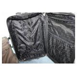 American Tourister Brown Garment Bag and Leisure International Black Upright Suitcase