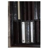 Collection of Vintage Music Cassette Tapes with Wooden Rack