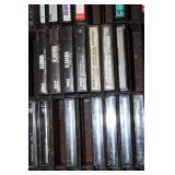Collection of Vintage Music Cassette Tapes with Wooden Rack