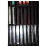 Collection of Vintage Music Cassette Tapes with Wooden Rack