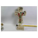 Decorative Collection: Cross Statue, Bird Figurine, and Glass Paperweights