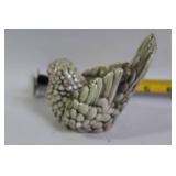 Decorative Collection: Cross Statue, Bird Figurine, and Glass Paperweights