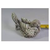 Decorative Collection: Cross Statue, Bird Figurine, and Glass Paperweights