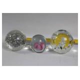 Decorative Collection: Cross Statue, Bird Figurine, and Glass Paperweights