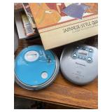 Assortment of Magazines, Quilting Book, Two Personal CD Players, and Assorted Decorative Items