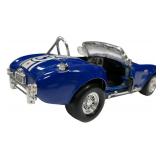 1:24 scale diecast model of a blue and white 1965 Shelby Cobra 427 S/C