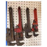 Collection of Hand Tools Including Pipe Wrenches and Claw Hammer