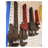 Collection of Hand Tools Including Pipe Wrenches and Claw Hammer