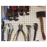 Collection of Hand Tools Including Pipe Wrenches and Claw Hammer