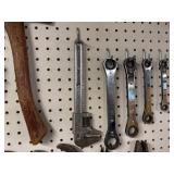 Collection of Hand Tools Including Pipe Wrenches and Claw Hammer