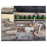 Collection of Industrial Metal Brackets, Clamps, and Glass Containers