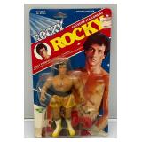 Est. $200.00 - $300.00 1983 PAC Phoenix Toys ROCKY Sylvester Stalllone As Rocky Fully poseable Doll On Original Card (New Old Stock) Missing Belt  Packaging Shows Wear
